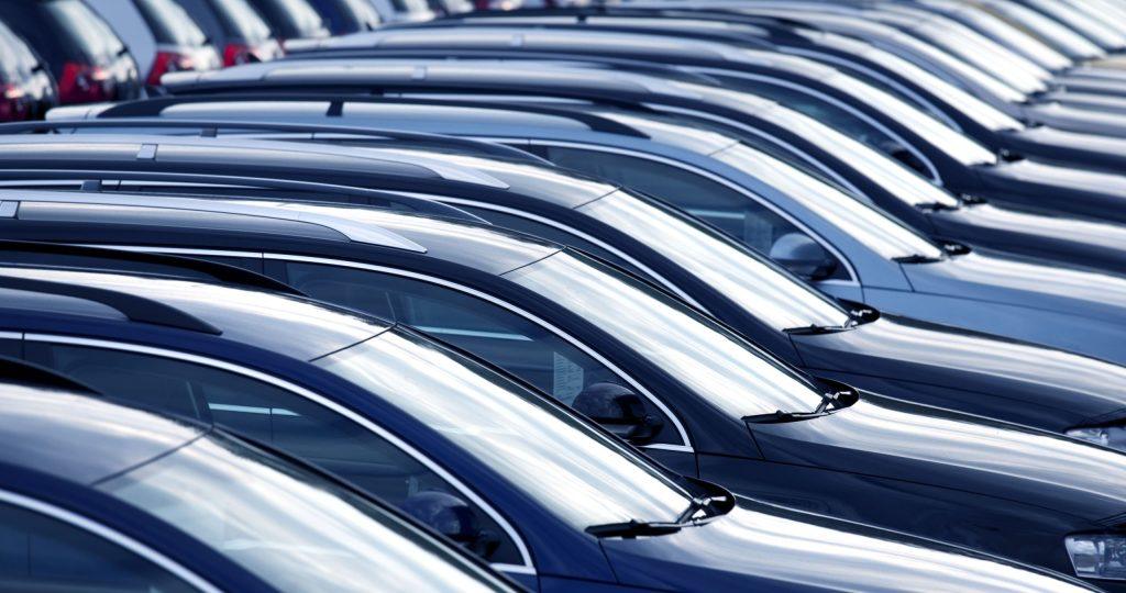 A row of blue and black automobiles
